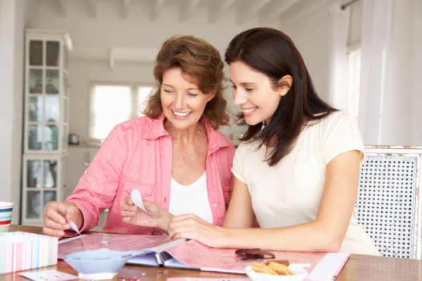 Mother and adult daughter scrapbooking