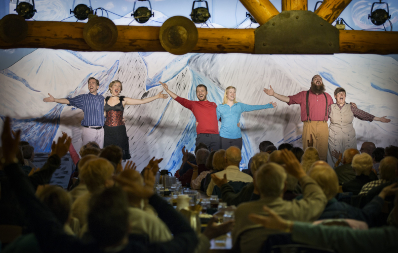 Performers singing on stage at Music of Denali Dinner Theater