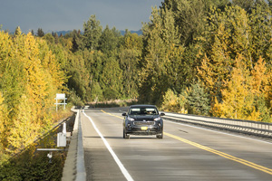 head-on view of black sedan on self-drive tour along a scenic alaska road